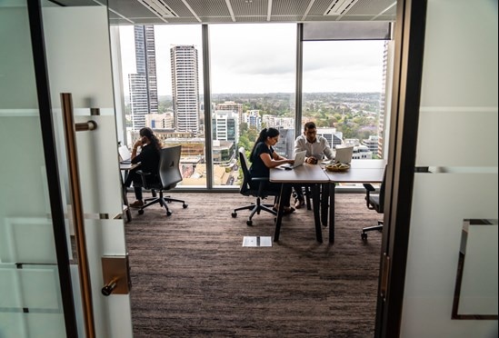 Professional people working in a furnished office space