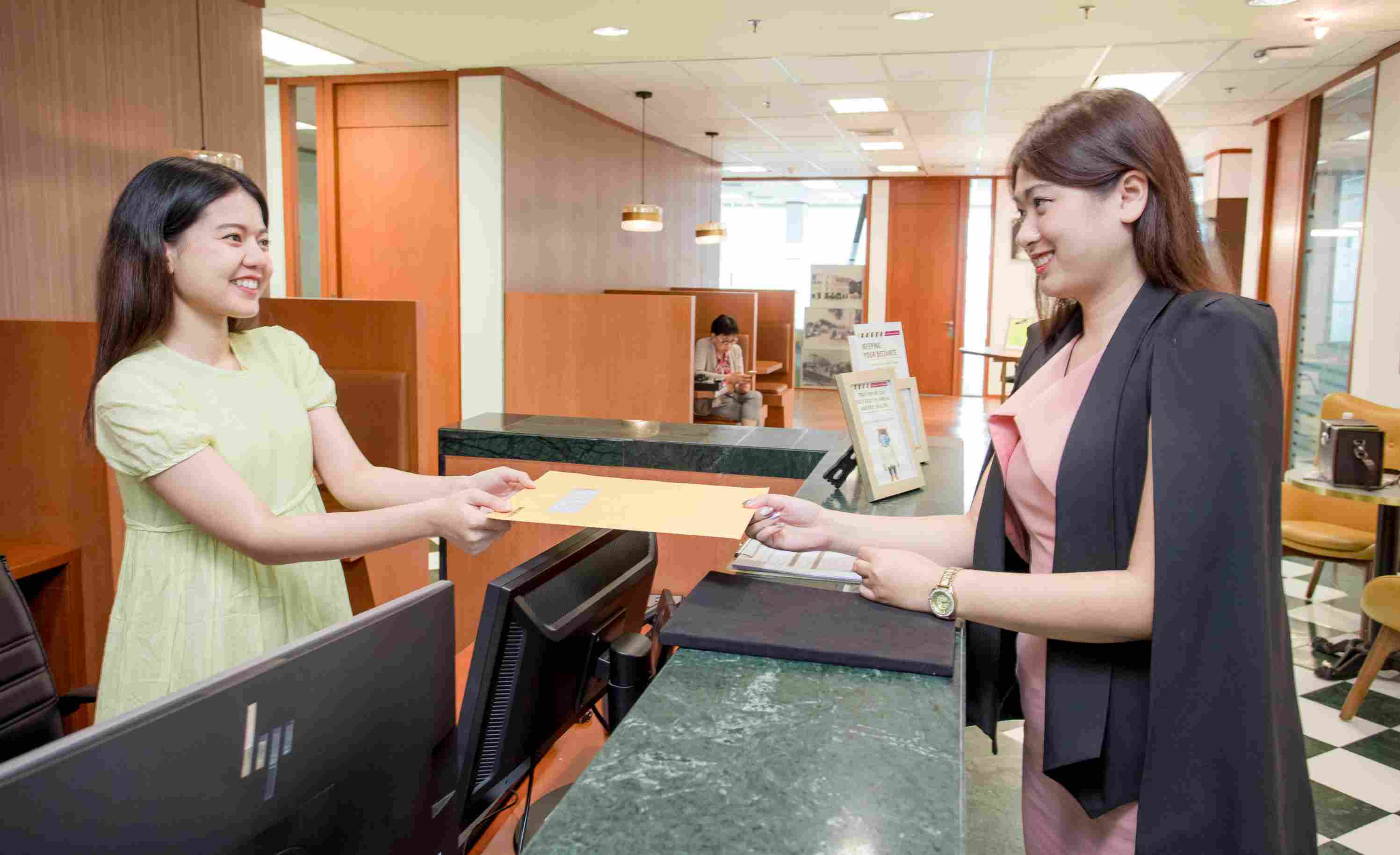 Receptionist helping clients at the front desk